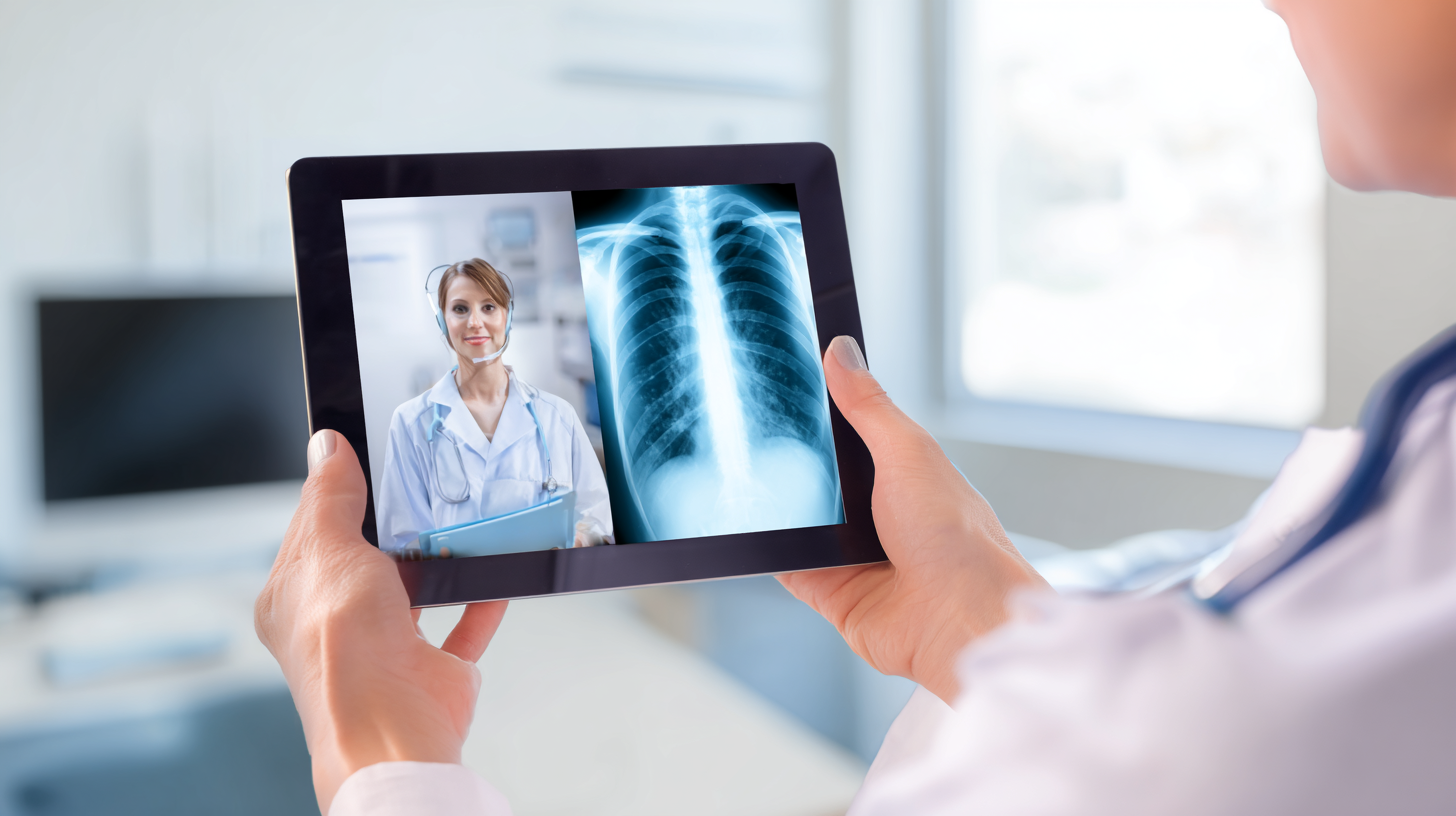 Close-up of a doctor’s hands holding a tablet at a patient’s bedside